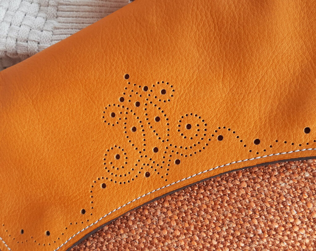 Détail du rabat et du motif style western perforé, de la besace Gabeline couleur cognac